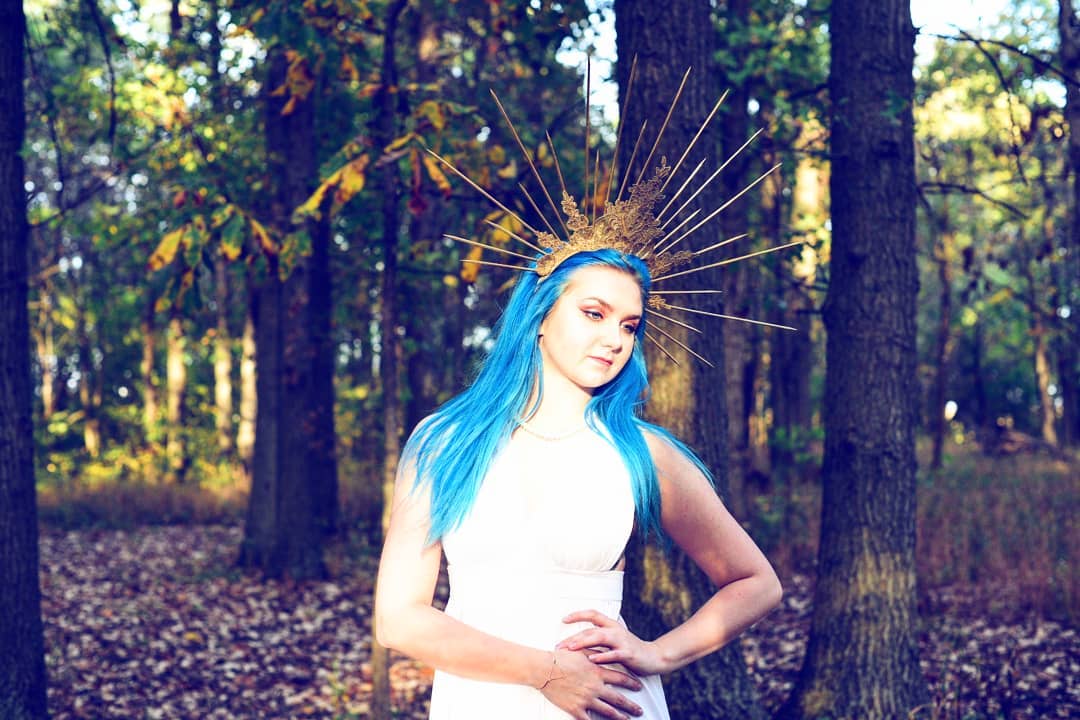 Find Faeted Creations on Social Media - Image of Nicole Modeling a large spiked gold lace crown in the sun light